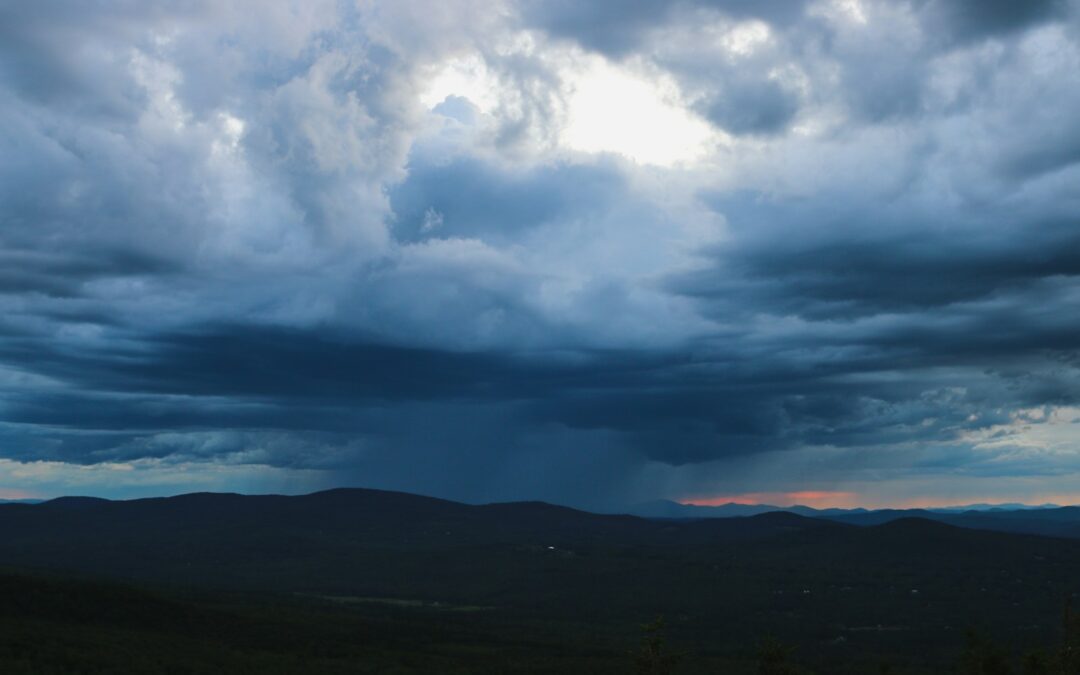 silhouette of mountain under blue and white skies